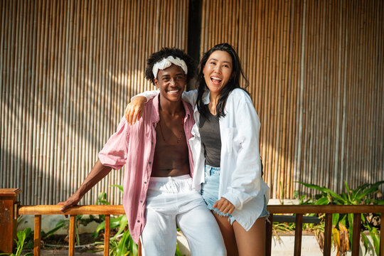 Happy interracial couple embracing and sharing a romantic moment during a tropical island getaway