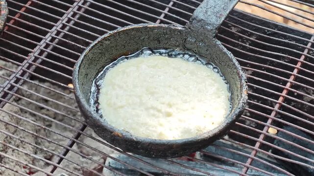 Making draniki in a rustic kitchen using simple tools and fresh potatoes