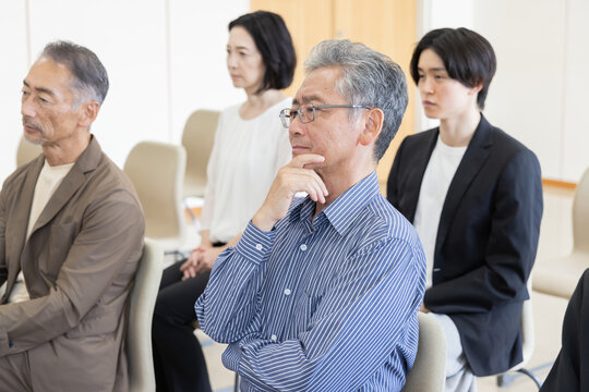 法廷の傍聴席で裁判を見守る真剣な傍聴人たち
