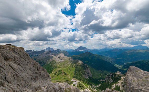 Majestic alpine mountain panorama and deep green valleys under a dramatic cloudy sky in the Dolomites