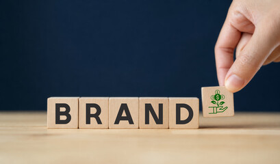 Brand equity concept. Wooden cube blocks with BRAND text and brand value icon on clear background and copy space. Brand and marketing management banner. © Omid studio