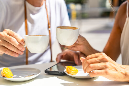Mature couple enjoying coffee and pastries al fresco breakfast