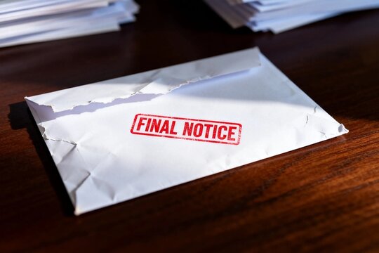 Torn envelope with 'Final Notice' stamp on desk