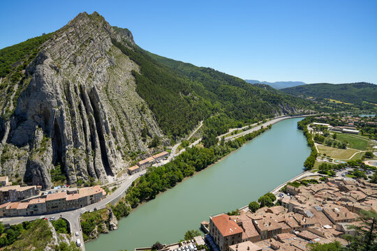 The spectacular rock formation known as the Rocher de la Baume and the Durance River flowing by in the French town of Sisteron.