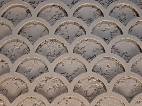 Each arch displays a distinct texture, with some uneven surfaces that add a tactile quality to the overall aesthetic. Unevenness creates an illusion of depth, making the pattern more visually engaging