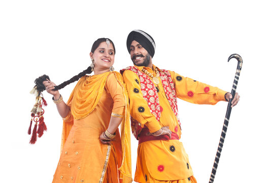 Sikh couple standing back to back