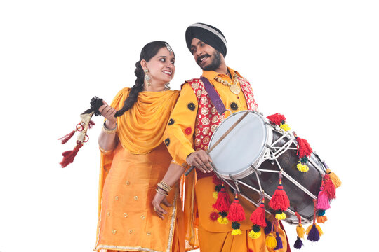Sikh bhangra dancers standing back to back