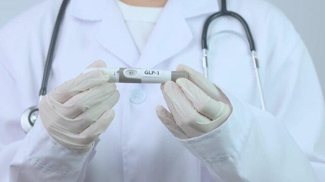 Professional doctor hand holding injection pen offers reassuring medical care, supporting healthy weight management treatment program clinic