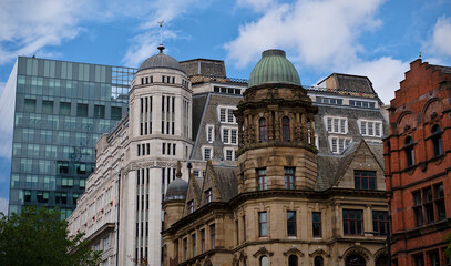 Fototapeta premium Manchester historic architecture with vintage stone dome and modern glass skyscraper facade, classic and contemporary city buildings mix