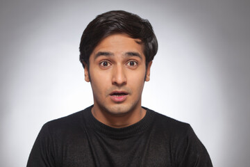 Obraz premium Portrait of a young man looking surprised