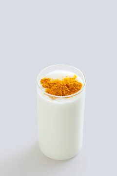 Glass of milk with turmeric powder