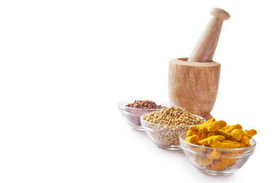 Bowls of spices with wooden mortar and pestle 