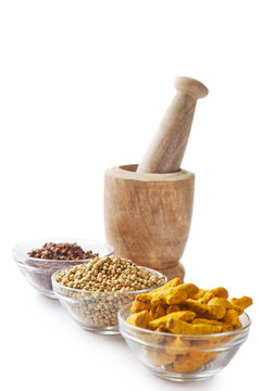 Bowls of spices with wooden mortar and pestle 