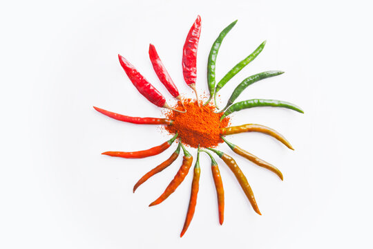 Close-up of red chilli powder with chilli peppers arranged in circle