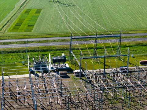 Aerial view of a transformer station and power line in Flevopolder