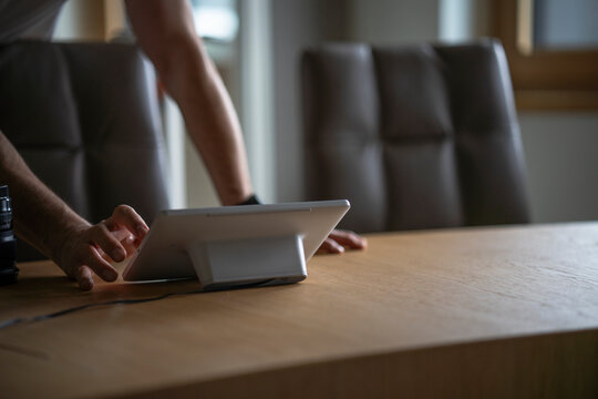 Man touches a tablet screen at the office desk