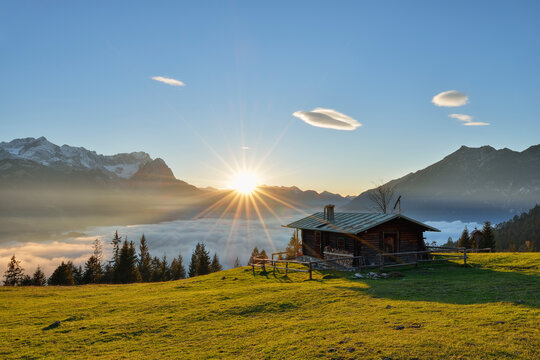 View of log cabin at Mt. Wank Zugspitze against cloudscape during sunset in Bavaria, Germany