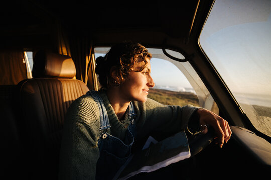 Hopeful driver navigates map during sunset drive.