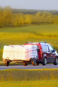 Bulk chemical container transport through green countryside