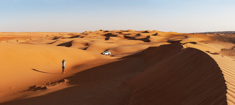 Man with off-road vehicle, taking pictures in the desert, Wahiba Sands, Oman