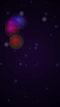 Moving colorful spheres cascading through a dark space