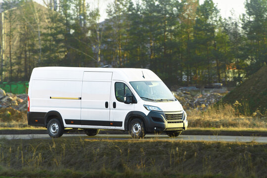 Delivery van crossing lush rural landscape