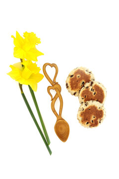 Traditional national symbols of Wales culture on white, daffodil flower St Davids Day symbol, love spoon token of love, welsh cake food treat.