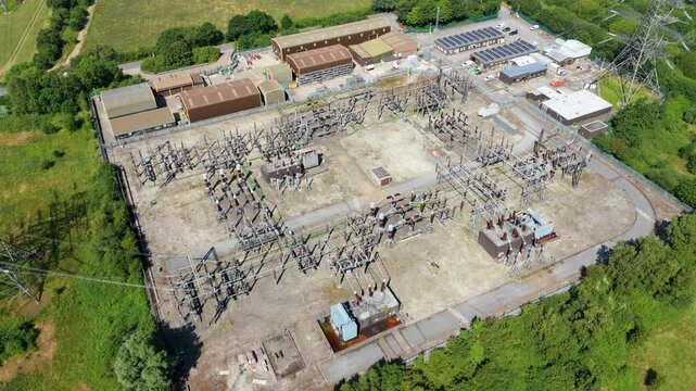 Aerial view of the massive Thorpe Marsh electrical substation showcasing intricate frameworks of high-voltage busbars and structural pylons.