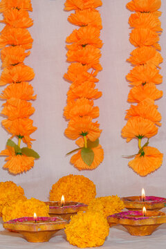 Traditional Diwali decoration with lit clay diyas and marigold flower garlands