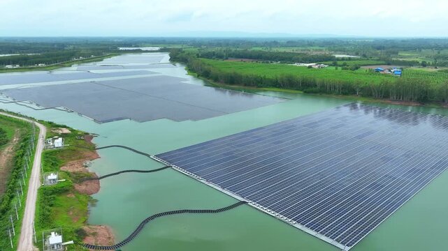 Aerial drone shot of a vast floating solar farm integrated with natural surroundings, representing clean energy transition, sustainability scale, and innovative water-based power generation. 4k.
