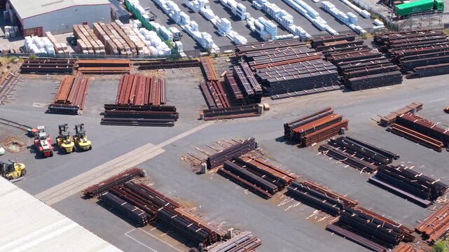 Aerial view of steel beams and reinforcing rebar bundles stacked on commercial port dock
