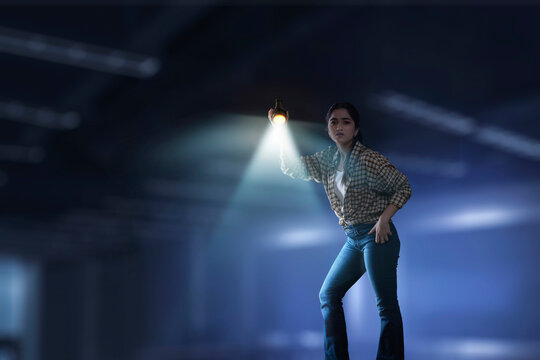 Young girl searching down with torch light