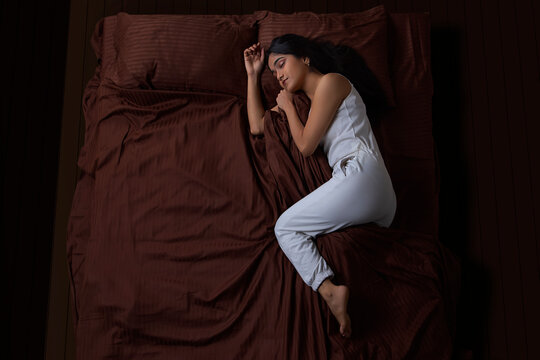Young beautiful girl sleeping on bed