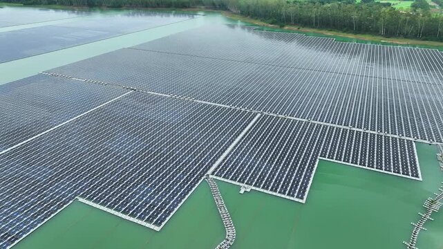 Aerial drone shot of a vast floating solar farm integrated with reservoir resources, representing sustainable energy transformation, water-energy synergy, and global clean power solutions. Thailand.
