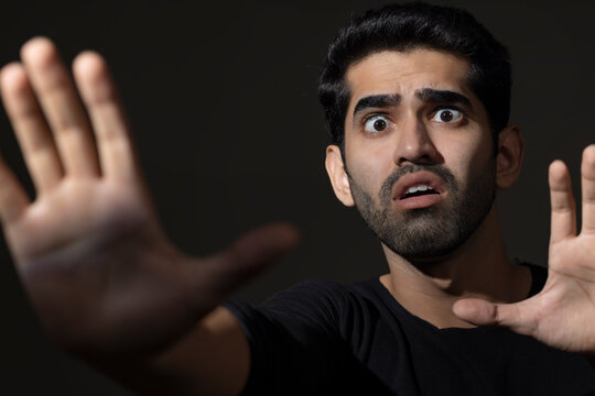 Portrait of a scared young man looking with wide eyes