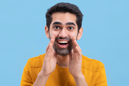Portrait of a surprised  young man looking at the camera with mouth opened