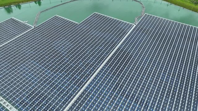 Aerial drone view of a massive floating solar farm on a reservoir, showcasing innovative photovoltaic technology, water-energy integration, land optimization, and ESG-driven clean energy transition.
