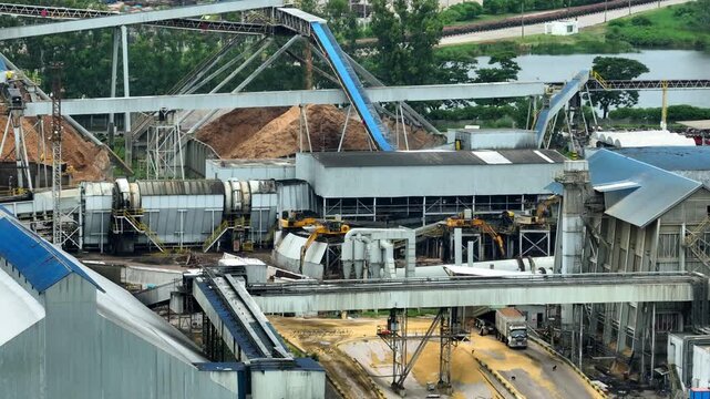 Aerial view of a large paper factory, showcasing heavy-duty infrastructure, biomass handling, pulp production systems, sustainable resources, efficient manufacturing within the global paper industry.
