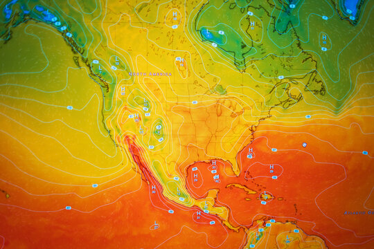 Photo of a digital weather screen showing a detailed color-coded high temperature map of North America. Intense orange and red colors illustrate a severe heatwave, global warming, and anomalous heat.