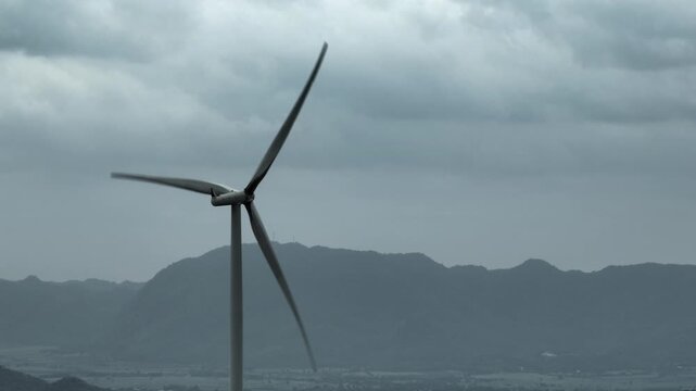 A wind turbine operating in severe climate conditions, representing clean energy transition, extreme weather resilience, and the ongoing partnership between nature and engineering innovation. 4k.

