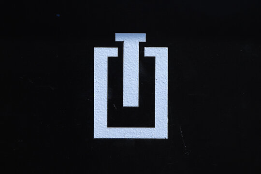 White Abstract T-shaped Icon on Black Background
