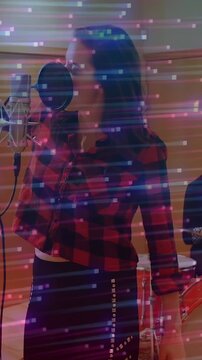 Vertical video: Vocalist at mic, music cue starting singing with pink glitch streaks over vocalist