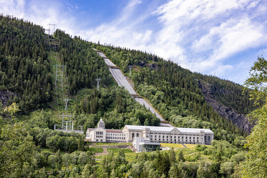 Grand building nestled among lush green hills