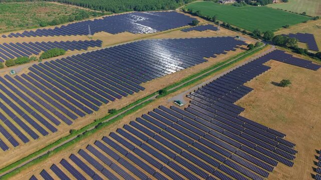 Aerial view of huge solar panel plant for renewable and sustainable energy generation in rural England