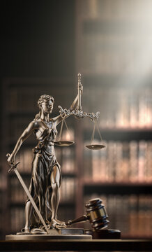 Legal Concept: Themis is the goddess of justice and the judge's gavel hammer as a symbol of law and order on the background of books