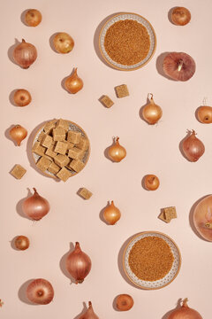 Natura and caramelized garden fresh organic onion with brown sugar rustic flat lay food styling on neutral beige background top view 
