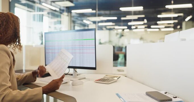 Employees in office typing at computers. Bright modern business workspace with monitors. Workstations show data while professionals collaborate. Concept of productivity and modern technology.