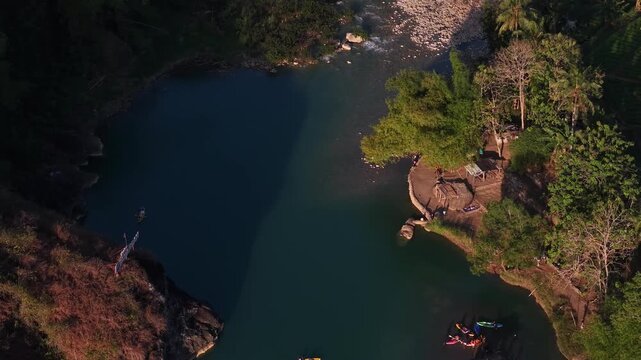 A cinematic aerial view of the Oya Valley in Kedungjati, a tranquil and clean river and canoeing destination. Located in Sriharjo, Bantul, Indonesia.