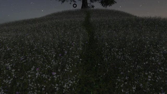 Single big oak tree standing on a blooming meadow next to a tire swing at night