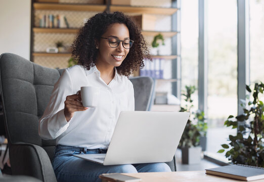 Young woman using laptop computer at modern office, businesswoman working. Online communication, business lifestyle, work or study connection, technology concept